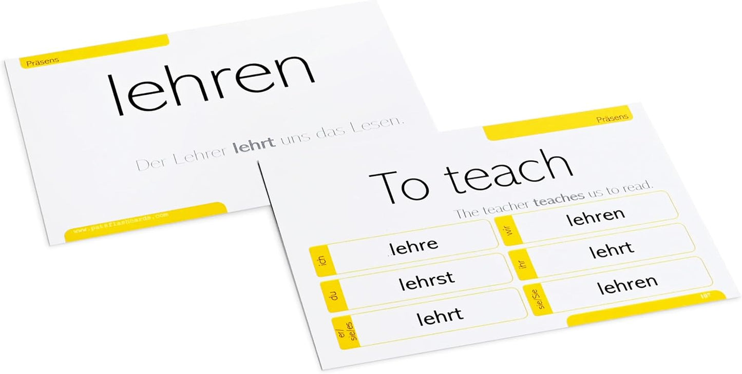 German language learning flashcards arranged on table featuring essential verbs and conjugation practice.